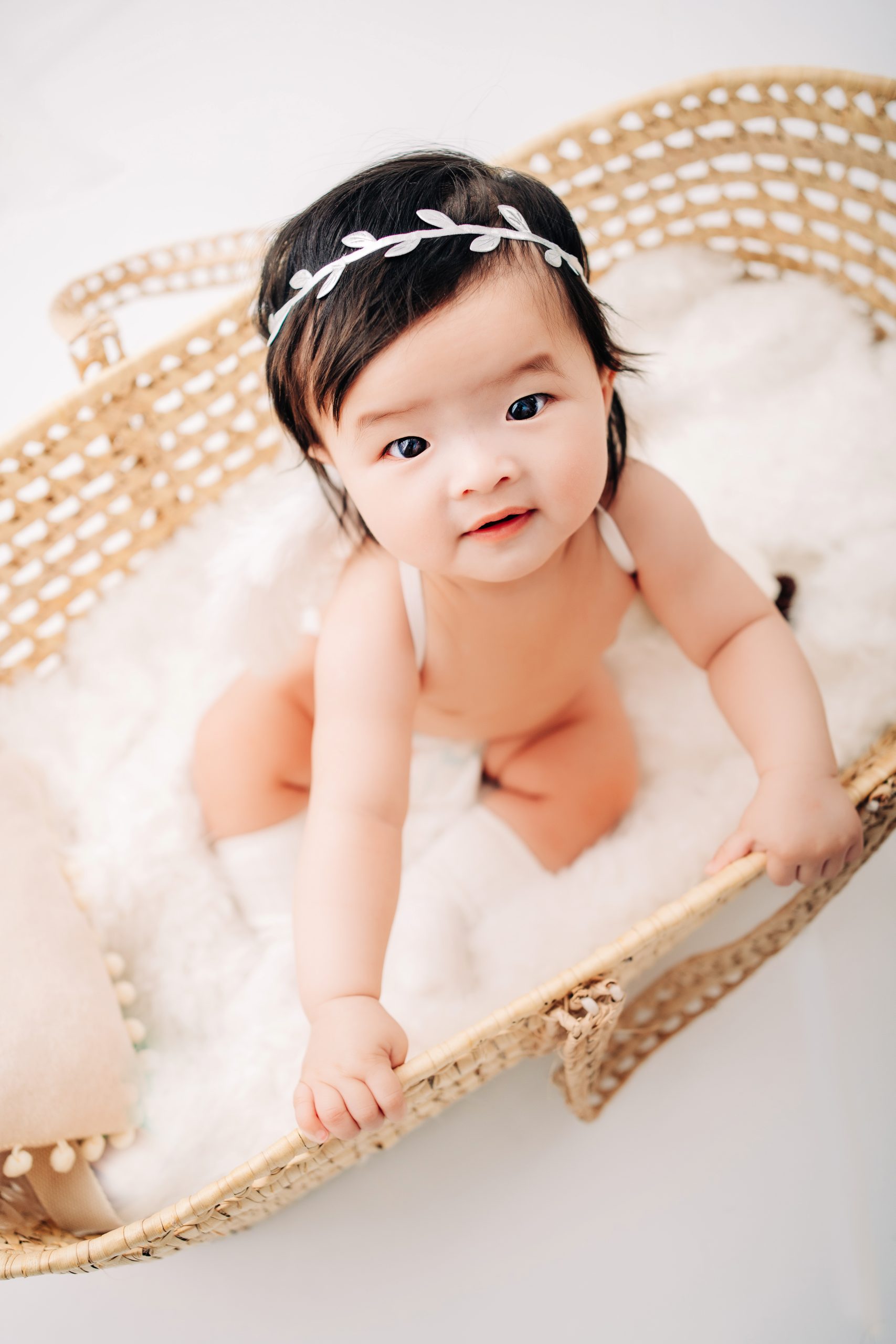 Baby girl in a basinet looking up